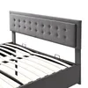 A close-up view of the headboard and slatted base of a gray upholstered bed frame. Produktbild-Vorschau