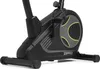 Close-up view of the base and flywheel housing of an exercise bike. Produktbild-Vorschau