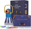 A children's storybook projector and its packaging are displayed on a white background, along with several colorful projection discs. Produktbild-Vorschau