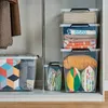 Storage boxes filled with various items are neatly stacked in a closet or storage area. Anteprima dell’immagine prodotto