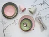 A flat lay of ceramic tableware including plates, bowls, and mugs, arranged on a white wooden surface with decorative branches. Náhľad obrázku produktu