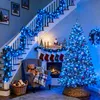 A cozy living room decorated for Christmas with a fireplace, Christmas tree, and garland. Náhled obrázku produktu