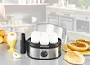 A person is in the background of a kitchen setting, with an egg cooker and breakfast items in the foreground. Produktbild-Vorschau