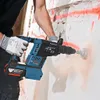 A person is using a Bosch hammer drill to make a hole in a wall. Produktbild-Vorschau