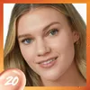 A close-up portrait of a woman with blonde hair, smiling and looking towards the camera. She is wearing a gold hoop earring. A circular overlay with the number '20' in white is in the bottom left corner. The image has an orange gradient border. Podgląd zdjęcia produktu