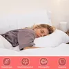A woman sleeping peacefully on a bed with white pillows and bedding. Produktbild-Vorschau