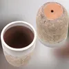 Two ceramic pots are shown against a light gray background. One pot is upright and viewed from the inside, showing its white rim and brown interior. The other pot is upside down, revealing its terracotta base with a drainage hole. Produktbild-Vorschau