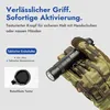 A hand wearing a camouflage glove holds a black tactical flashlight. Podgląd zdjęcia produktu