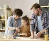A family is baking in a kitchen. Produktbild-Vorschau