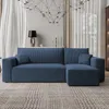 A blue sectional sofa is placed in a living room setting with curtains and a chandelier. Produktbild-Vorschau