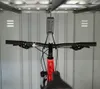 A bicycle is hanging from a hook inside a storage unit. Produktbild-Vorschau
