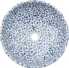 A top-down view of a round ceramic sink with a blue floral pattern. Náhled obrázku produktu