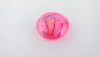 A pink container with earplugs inside, set against a white background. Produktbild-Vorschau