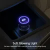 A car's center console with a glowing car charger plugged in. Produktbild-Vorschau