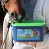 A horse is shown sniffing a container of Eggersmann Mineral Bricks, held by a person. Produktbild-Vorschau