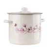 A cream-colored enamel pot with a lid, decorated with pink magnolia flowers and a purple butterfly. Produktbild-Vorschau