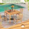 A wooden table and chairs set by a swimming pool. Anteprima dell’immagine prodotto