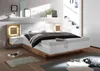 A modern bedroom with a large bed, nightstands, and shelves. Produktbild-Vorschau