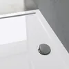 A close-up view of a white shower tray with a chrome drain. Produktbild-Vorschau