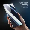 A hand holding a smartphone with a screen protector applied, against a dark blue background. Produktbild-Vorschau