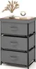 A three-drawer fabric dresser with a wooden top, decorated with a vase of dried flowers and a decorative object. Podgląd zdjęcia produktu