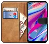 A book-style phone case with a phone inside, showing cards and banknotes in the wallet section. Anteprima dell’immagine prodotto