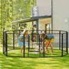 Two children playing with a dog inside a black metal playpen in a backyard. Voir les images du produit