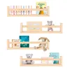 Four wooden shelves mounted on a white background, each displaying books and decorative items. Náhľad obrázku produktu