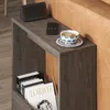 A modern side table next to a couch, with books and a cup of tea on top. Produktbild-Vorschau