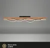 A modern wooden ceiling lamp with wavy LED lights against a plain gray background. Produktbild-Vorschau