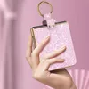 A hand holding a pink glittery phone case with a gold ring. Produktbild-Vorschau