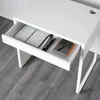 A close-up view of an open drawer in a white desk, revealing office supplies. Produktbild-Vorschau