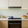 A modern kitchen counter with a built-in oven, induction stovetop, and range hood. Náhľad obrázku produktu