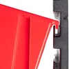 A close-up view of a red storage bin attached to a black pegboard system. Náhled obrázku produktu