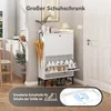 A white shoe cabinet with shoes and an umbrella is shown in a hallway next to a door and a chair. Produktbild-Vorschau