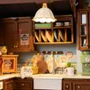 A miniature kitchen scene with cabinets, shelves, dishes, and appliances. Náhľad obrázku produktu