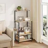 A kitchen shelf unit with various items displayed on it, placed next to a sofa and a window with curtains. Produktbild-Vorschau