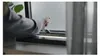 A person's hand is shown opening a window. Produktbild-Vorschau