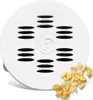 A white pasta maker disc with a pile of dried pasta shapes next to it. Produktbild-Vorschau