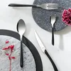 A flat lay of cutlery on a marble surface with decorative elements. Podgląd zdjęcia produktu