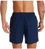 The back view of a man wearing navy blue swim shorts. Podgląd zdjęcia produktu