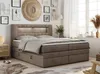 A bedroom scene with a large boxspring bed as the focal point, decorated with artwork and plants. Produktbild-Vorschau