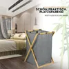A laundry basket is shown in a bedroom setting. Produktbild-Vorschau