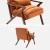 Collage of an orange velvet armchair with a wooden frame, shown from two different angles against a white background. Produktbild-Vorschau