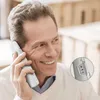 A man is holding a cordless phone to his ear and smiling. Produktbild-Vorschau