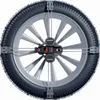 A close-up view of a car tire with snow chains installed. Produktbild-Vorschau