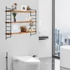 A bathroom with a toilet and a wall shelf decorated with various items. Produktbild-Vorschau