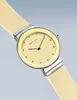 A close-up studio shot of a Bering watch with a yellow dial and a light yellow silicone strap, against a light gray background. Produktbild-Vorschau