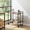 A two-tiered rolling cart with office supplies is placed next to a window with a view of greenery. Voir les images du produit