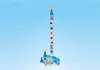 A toy castle with a tall tower and a slide, set against a plain blue background. Produktbild-Vorschau